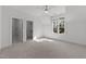 Bright bedroom with large windows and a view, complemented by neutral carpeting and ceiling fan at 4501 Bartlett Dr, Raleigh, NC 27609