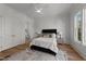 Bedroom with hardwood floors, ceiling fan, and a Primary bath at 4501 Bartlett Dr, Raleigh, NC 27609