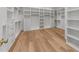 Spacious walk-in closet with custom shelving and hardwood floors at 4501 Bartlett Dr, Raleigh, NC 27609