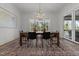 Elegant dining room features stylish chandelier, black chairs, and sliding glass doors to outdoor space at 4501 Bartlett Dr, Raleigh, NC 27609