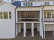 A back exterior shot highlighting a covered porch and deck supported by white brick columns at 4501 Bartlett Dr, Raleigh, NC 27609