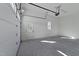 A clean two-car garage with white walls, a side entry door, and an automatic garage door opener at 4501 Bartlett Dr, Raleigh, NC 27609