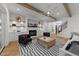 Cozy living room featuring a fireplace, exposed beam ceilings, and striped rug for a modern look at 4501 Bartlett Dr, Raleigh, NC 27609