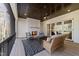 A cozy outdoor covered patio with a fireplace, comfortable seating, and a patterned outdoor rug at 4501 Bartlett Dr, Raleigh, NC 27609