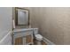 A stylish powder room with patterned wallpaper, a marble countertop vanity, and a decorative framed mirror at 4501 Bartlett Dr, Raleigh, NC 27609
