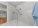 Luxurious shower featuring marble walls, dual shower heads, and a glass enclosure at 4501 Bartlett Dr, Raleigh, NC 27609