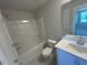 Bright bathroom with a shower and bathtub combo and a white vanity with chrome fixtures at 500 Yeowell Dr, Chapel Hill, NC 27514