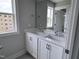 Bathroom featuring a double sink vanity with white cabinets, modern faucets and a large mirror at 500 Yeowell Dr, Chapel Hill, NC 27514