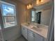 Bright bathroom featuring a double vanity, large mirror and natural light at 500 Yeowell Dr, Chapel Hill, NC 27514