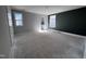 Unfinished primary bedroom featuring a modern accent wall, natural light, and en-suite bathroom at 500 Yeowell Dr, Chapel Hill, NC 27514