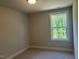 Small bedroom with a window and carpeted floors at 500 Yeowell Dr, Chapel Hill, NC 27514