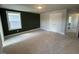Spacious bedroom with neutral carpet and paint, complemented by a large window and ample natural light at 500 Yeowell Dr, Chapel Hill, NC 27514