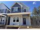 Charming two-story home with gray siding, black shutters, and a cozy front porch, inviting comfort and modern style at 500 Yeowell Dr, Chapel Hill, NC 27514