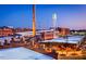 Aerial view of a renovated brick factory complex with a smokestack and water tower at 500 Yeowell Dr, Chapel Hill, NC 27514