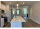 Open kitchen featuring stainless steel appliances, a large island, and a view of the home's living space at 500 Yeowell Dr, Chapel Hill, NC 27514