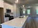 Open kitchen featuring stainless steel appliances, an island, and a view of the open floor plan at 500 Yeowell Dr, Chapel Hill, NC 27514