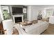 Living room showcasing a fireplace, mantle, modern décor, and a glimpse into the open-concept kitchen at 500 Yeowell Dr, Chapel Hill, NC 27514