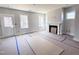 Spacious living room with fireplace, large windows, and unfinished floors, perfect for customization at 500 Yeowell Dr, Chapel Hill, NC 27514
