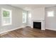 Bright living room showcasing hardwood floors, a fireplace, and abundant natural light through multiple windows at 500 Yeowell Dr, Chapel Hill, NC 27514