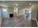 Spacious living room with fireplace, wood floors, and views of the kitchen and entryway at 500 Yeowell Dr, Chapel Hill, NC 27514