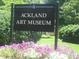 Ackland Art Museum sign surrounded by flowers and greenery at 500 Yeowell Dr, Chapel Hill, NC 27514