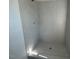 Tiled shower featuring gray walls and a hexagon-tiled shower floor at 500 Yeowell Dr, Chapel Hill, NC 27514