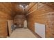 Cozy attic space featuring wood paneling, carpet, and storage shelving at 531 N Main St, Graham, NC 27253