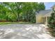 Large backyard with mature trees, garden, and a yellow home at 531 N Main St, Graham, NC 27253