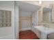 Elegant bathroom with pedestal sink, glass block window, and tile accents at 531 N Main St, Graham, NC 27253