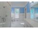 Bright bathroom with marble floors, white fixtures, and walk-in shower at 531 N Main St, Graham, NC 27253