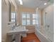 Classic bathroom with soaking tub, shower, and pedestal sink at 531 N Main St, Graham, NC 27253
