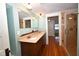 Bathroom featuring a double vanity with a granite countertop, and a tiled walk-in shower at 531 N Main St, Graham, NC 27253