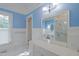 Bathroom with large vanity, white fixtures, and a large mirror showing the shower at 531 N Main St, Graham, NC 27253