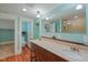 Bathroom with double vanity, stone countertops, and natural light at 531 N Main St, Graham, NC 27253