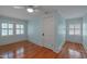 Bedroom with hardwood floors, neutral paint, and double-hung windows at 531 N Main St, Graham, NC 27253