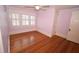 Cozy bedroom featuring hardwood floors, a ceiling fan, natural light, and a neutral color palette at 531 N Main St, Graham, NC 27253