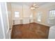 Spacious bedroom with large windows, hardwood floors, and built-in shelving and cabinets at 531 N Main St, Graham, NC 27253