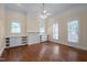 Spacious bedroom with hardwood floors, three windows, and built-in storage at 531 N Main St, Graham, NC 27253