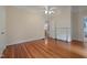 Bedroom with hardwood floors, fireplace, and doorway to en-suite bathroom at 531 N Main St, Graham, NC 27253