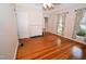 Charming bedroom with hardwood floors, windows with curtains, and fireplace at 531 N Main St, Graham, NC 27253