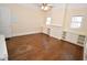 Large bedroom with natural light, hardwood floors, built-in shelving and cabinets, and neutral paint at 531 N Main St, Graham, NC 27253