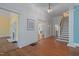 Entryway with hardwood floors, staircase, and views into the living room and sunroom at 531 N Main St, Graham, NC 27253