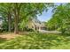 Charming yellow home with mature shade trees and a covered front porch at 531 N Main St, Graham, NC 27253