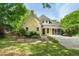 Beautiful yellow home with mature trees, landscaping, and covered front porch at 531 N Main St, Graham, NC 27253