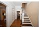 Foyer boasts hardwood floors, stairway, and open doorway to another room at 531 N Main St, Graham, NC 27253