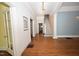 Foyer features hardwood floors, stairs, and doorway with natural light at 531 N Main St, Graham, NC 27253