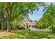 Inviting yellow home with mature trees, a spacious yard, and a charming front porch at 531 N Main St, Graham, NC 27253
