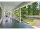 Spacious front porch with white railings and a swing offering a relaxing outdoor space at 531 N Main St, Graham, NC 27253