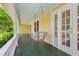 Cozy porch with a swing perfect for relaxing, complemented by classic details and natural light at 531 N Main St, Graham, NC 27253