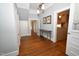 Hallway with hardwood floors, gray walls, and doorways leading to other rooms at 531 N Main St, Graham, NC 27253